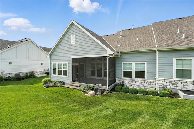 13300 W 174th Pl, Overland Park, KS 66221 - rear view of house featuring a sunroom, a lawn, stone siding, and roof with shingles