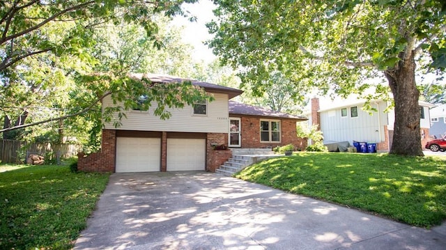 12205 W 67th Ter, Shawnee, KS 66216 - split level home featuring brick siding, an attached garage, and driveway