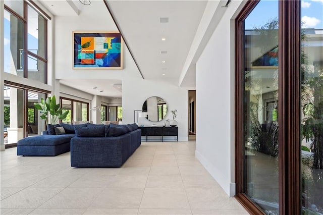 10712 W 165th St, Overland Park, KS 66221 - living room featuring light tile patterned flooring, healthy amount of natural light, and a towering ceiling