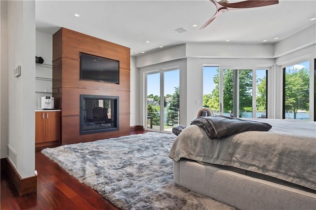 10712 W 165th St, Overland Park, KS 66221 - bedroom with access to exterior, dark wood-style floors, a large fireplace, recessed lighting, and a ceiling fan