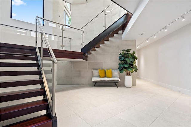 10712 W 165th St, Overland Park, KS 66221 - staircase with tile patterned floors and rail lighting