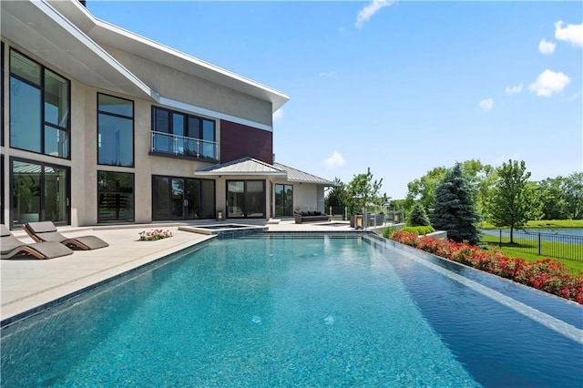 10712 W 165th St, Overland Park, KS 66221 - view of swimming pool featuring a patio area and a pool with connected hot tub