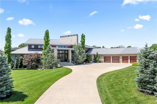 10712 W 165th St, Overland Park, KS 66221 - contemporary home featuring a metal roof, driveway, a front lawn, and stucco siding