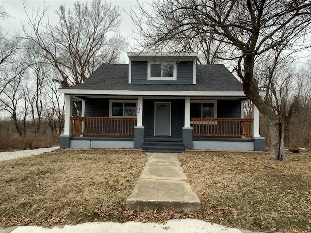 3046 N 27th St, Kansas City, KS 66104 - bungalow-style house with covered porch and a shingled roof