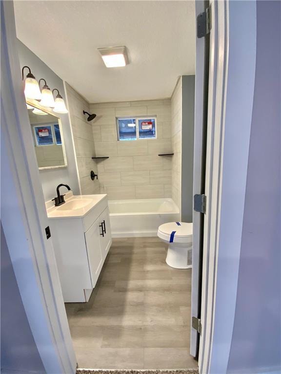 3046 N 27th St, Kansas City, KS 66104 - bathroom with vanity, wood finished floors, and shower / bath combination