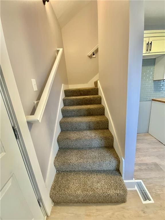 3046 N 27th St, Kansas City, KS 66104 - stairway featuring wood finished floors