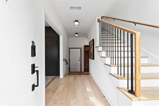 529 E 19th St, Kansas City, MO 64108 - stairway featuring hardwood / wood-style floors and baseboards