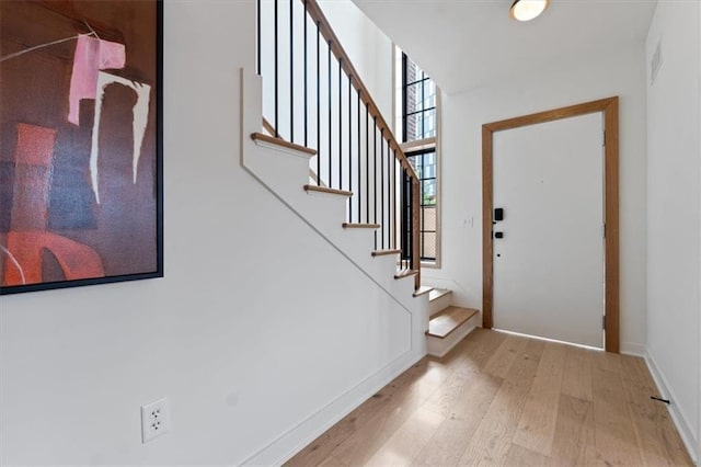 529 E 19th St, Kansas City, MO 64108 - entryway featuring light wood finished floors and stairway