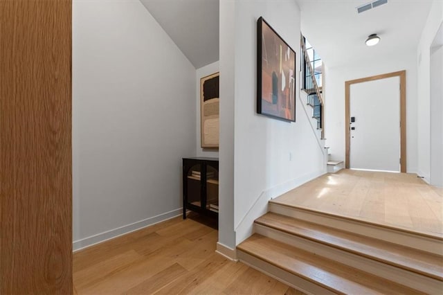 529 E 19th St, Kansas City, MO 64108 - hall with stairs, light wood finished floors, and vaulted ceiling
