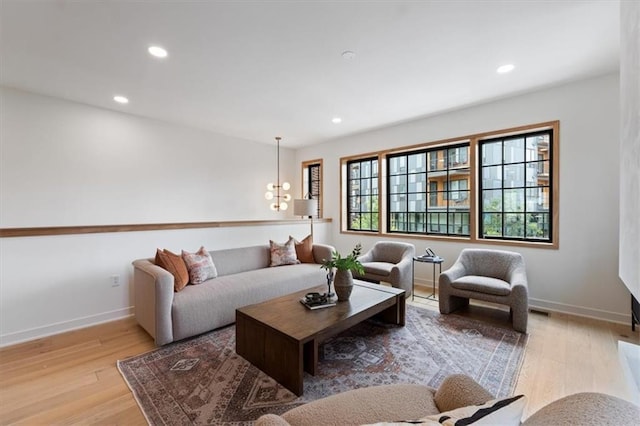 529 E 19th St, Kansas City, MO 64108 - living room with wood finished floors, recessed lighting, and a chandelier