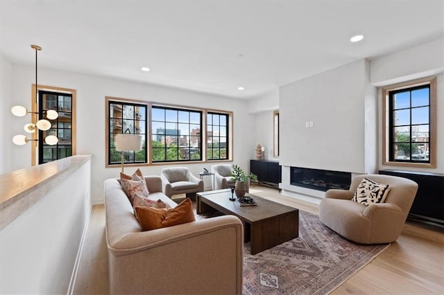 529 E 19th St, Kansas City, MO 64108 - living room featuring light wood-style floors, recessed lighting, and a glass covered fireplace