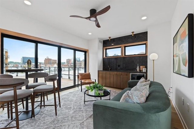 529 E 19th St, Kansas City, MO 64108 - living room with light wood finished floors, recessed lighting, a view of city, a ceiling fan, and beverage cooler
