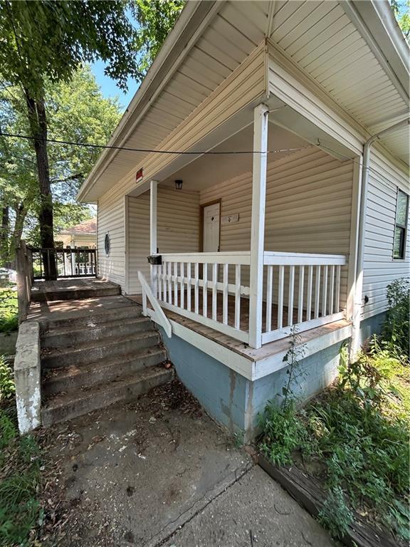 907 S Cedar Ave, Independence, MO 64052 - view of home's exterior with a porch