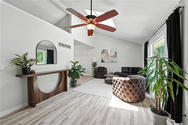 2903 E 107th Ter, Kansas City, MO 64137 - living area with wood finished floors, ceiling fan, and high vaulted ceiling