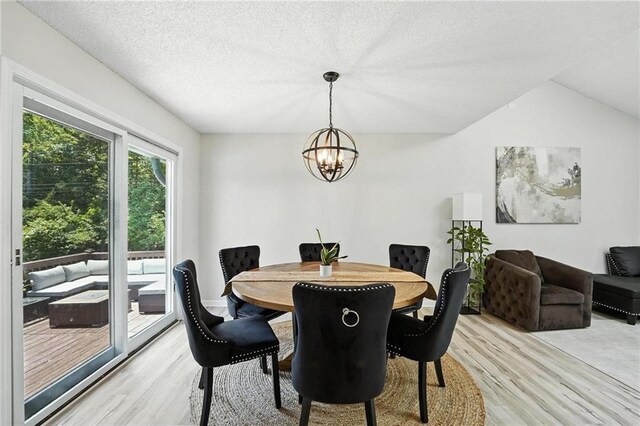 2903 E 107th Ter, Kansas City, MO 64137 - dining area with light wood-style floors, a chandelier, and lofted ceiling