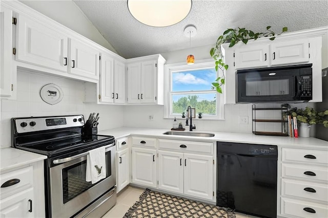 2903 E 107th Ter, Kansas City, MO 64137 - kitchen with black appliances, a textured ceiling, lofted ceiling, white cabinets, and light countertops