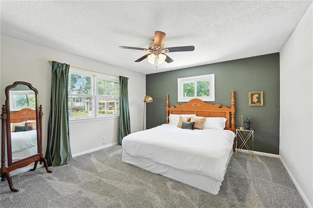 2903 E 107th Ter, Kansas City, MO 64137 - bedroom with multiple windows, carpet, a textured ceiling, and ceiling fan