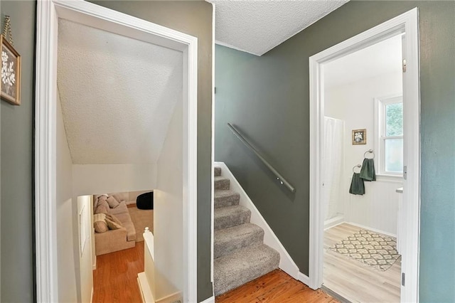 2903 E 107th Ter, Kansas City, MO 64137 - staircase featuring wood finished floors and a textured ceiling