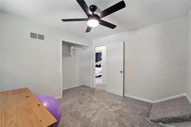 2903 E 107th Ter, Kansas City, MO 64137 - unfurnished bedroom featuring carpet, a textured ceiling, a closet, and ceiling fan