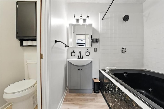 2903 E 107th Ter, Kansas City, MO 64137 - bathroom featuring vanity, wood finished floors, and a combined bath / shower with jetted tub