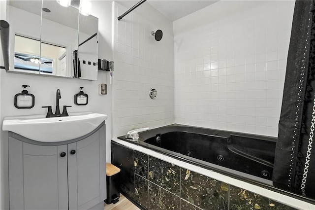 2903 E 107th Ter, Kansas City, MO 64137 - full bath featuring a combined bath / shower with jetted tub, vanity, and wood finished floors
