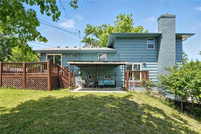 2903 E 107th Ter, Kansas City, MO 64137 - rear view of property with a wooden deck, a chimney, an outdoor hangout area, a lawn, and a patio