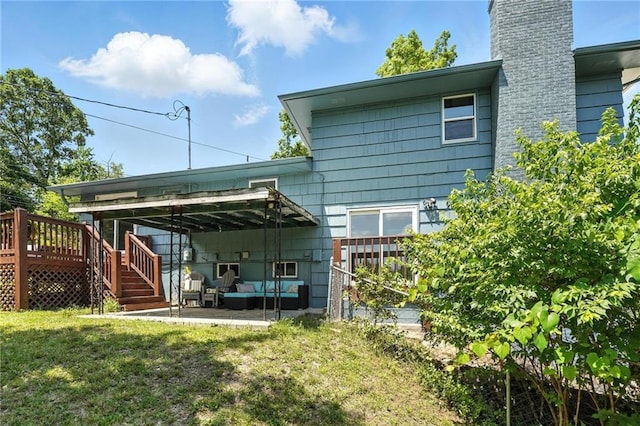 2903 E 107th Ter, Kansas City, MO 64137 - rear view of house featuring a chimney, a wooden deck, a lawn, an outdoor living space, and a patio