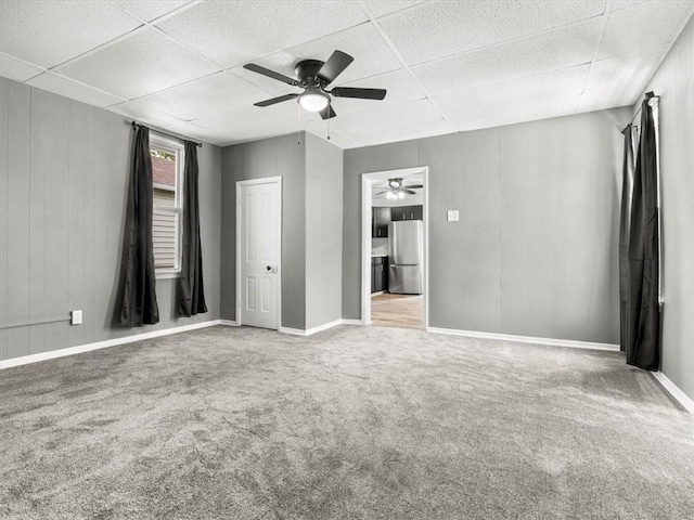 915 N 24th St, Saint Joseph, MO 64506 - unfurnished bedroom with freestanding refrigerator, a drop ceiling, carpet, and ceiling fan
