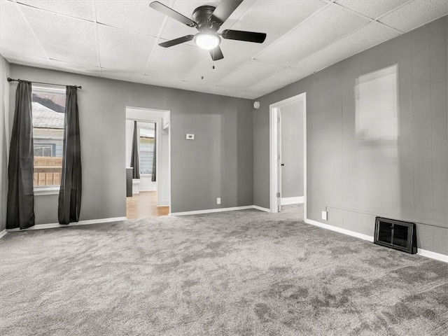 915 N 24th St, Saint Joseph, MO 64506 - unfurnished bedroom featuring carpet floors, a paneled ceiling, connected bathroom, and a ceiling fan