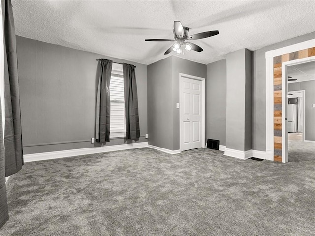 915 N 24th St, Saint Joseph, MO 64506 - unfurnished bedroom with carpet, a textured ceiling, and a ceiling fan