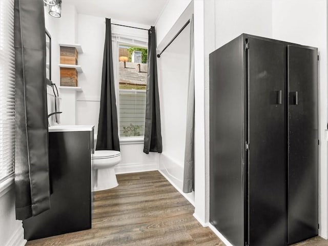 915 N 24th St, Saint Joseph, MO 64506 - bathroom with wood finished floors and shower / tub combo with curtain