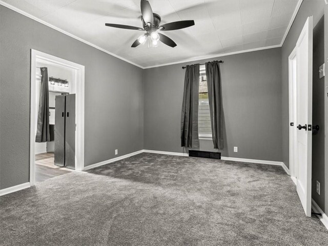915 N 24th St, Saint Joseph, MO 64506 - unfurnished room with crown molding, a ceiling fan, and dark colored carpet