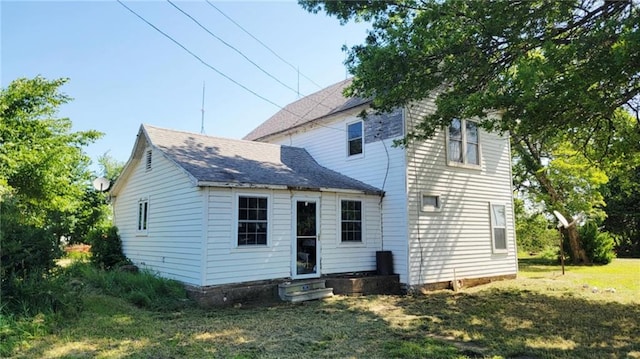 18400 Keitel Rd, Parker, KS 66072 - back of property with entry steps, a shingled roof, and a lawn