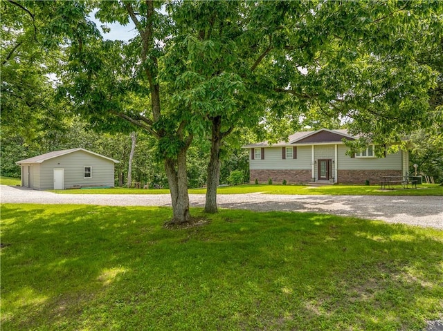 33383 Acorn Ln, Warsaw, MO 65355 - view of front facade with curved driveway, a front yard, brick siding, and entry steps