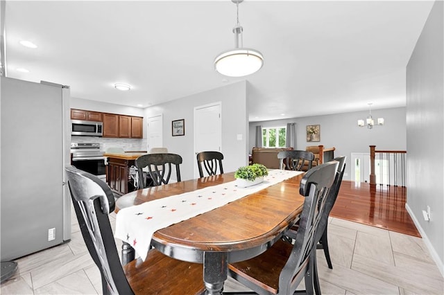33383 Acorn Ln, Warsaw, MO 65355 - dining area featuring a chandelier and baseboards