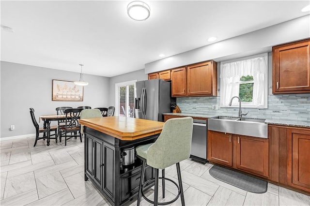 33383 Acorn Ln, Warsaw, MO 65355 - kitchen featuring stainless steel fridge with ice dispenser, backsplash, brown cabinets, pendant lighting, and recessed lighting
