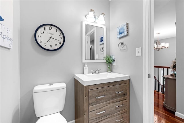 33383 Acorn Ln, Warsaw, MO 65355 - half bathroom featuring vanity, wood finished floors, and a chandelier
