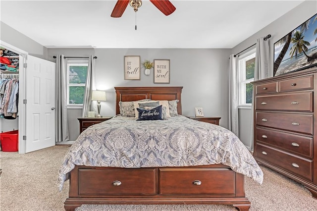 33383 Acorn Ln, Warsaw, MO 65355 - carpeted bedroom with multiple windows, a spacious closet, a ceiling fan, and a closet