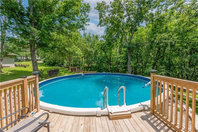 33383 Acorn Ln, Warsaw, MO 65355 - outdoor pool with a wooden deck, a yard, and view of scattered trees