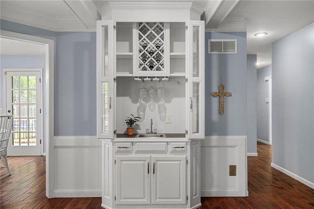 11530 Hemlock St, Overland Park, KS 66210 - indoor wet bar with dark wood-type flooring, ornamental molding, and wainscoting