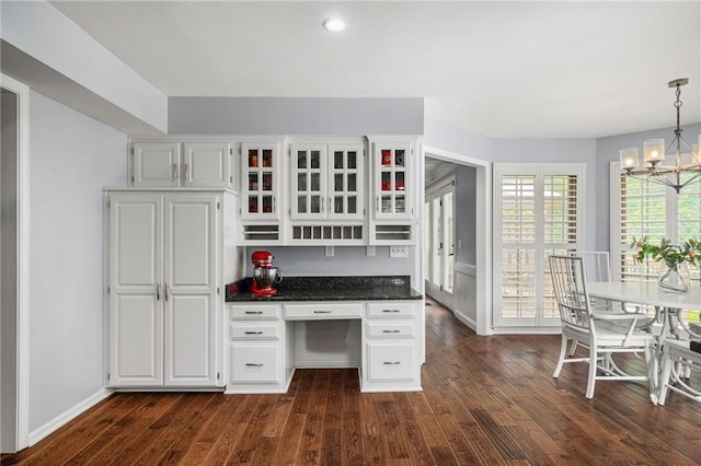 11530 Hemlock St, Overland Park, KS 66210 - kitchen featuring a chandelier, dark wood-style flooring, white cabinetry, glass insert cabinets, and hanging light fixtures