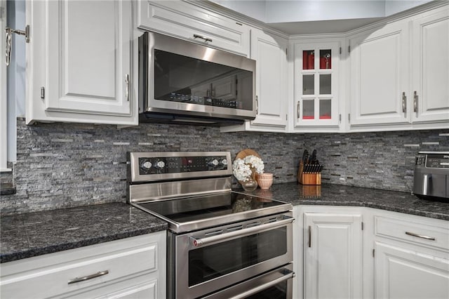 11530 Hemlock St, Overland Park, KS 66210 - kitchen with stainless steel appliances, white cabinets, decorative backsplash, and glass insert cabinets