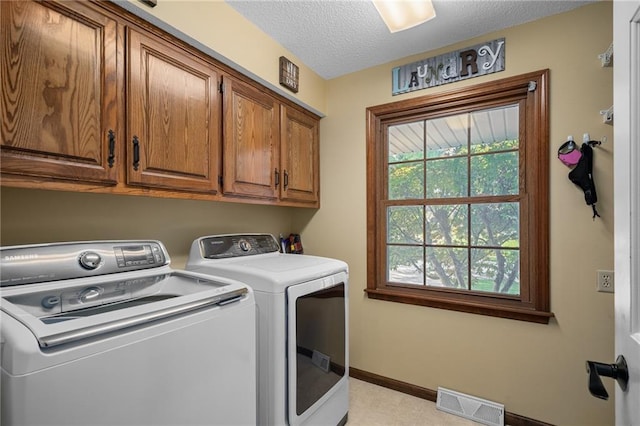11530 Hemlock St, Overland Park, KS 66210 - washroom with cabinet space, washer and clothes dryer, and a textured ceiling