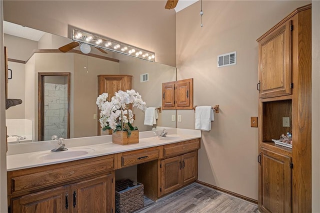 11530 Hemlock St, Overland Park, KS 66210 - bathroom with ceiling fan, double vanity, wood finished floors, and a shower