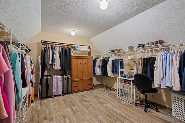 11530 Hemlock St, Overland Park, KS 66210 - walk in closet featuring wood finished floors and lofted ceiling