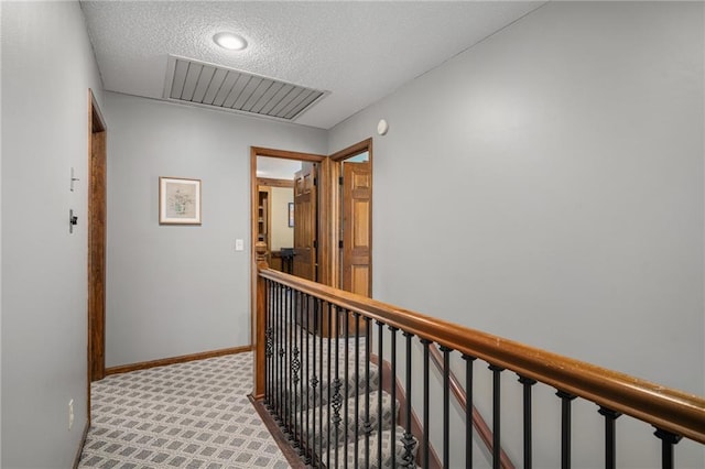 11530 Hemlock St, Overland Park, KS 66210 - hallway featuring an upstairs landing, carpet flooring, and a textured ceiling