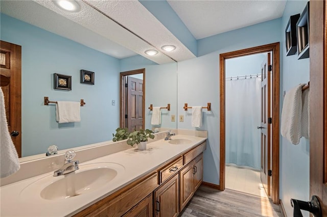 11530 Hemlock St, Overland Park, KS 66210 - full bathroom featuring double vanity and wood finished floors