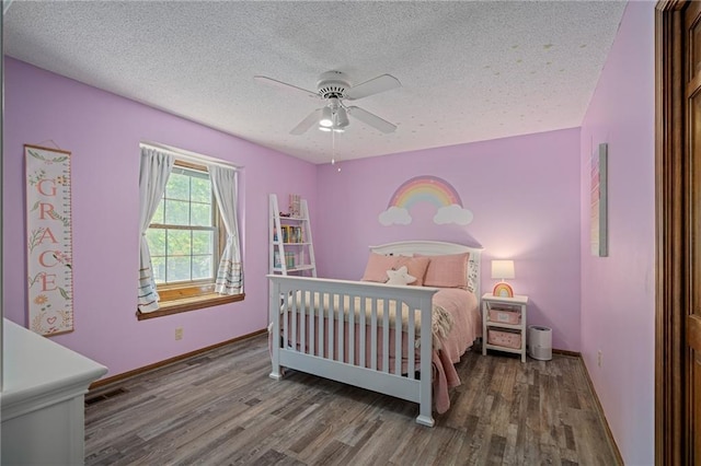 11530 Hemlock St, Overland Park, KS 66210 - bedroom with wood finished floors, a textured ceiling, and a ceiling fan