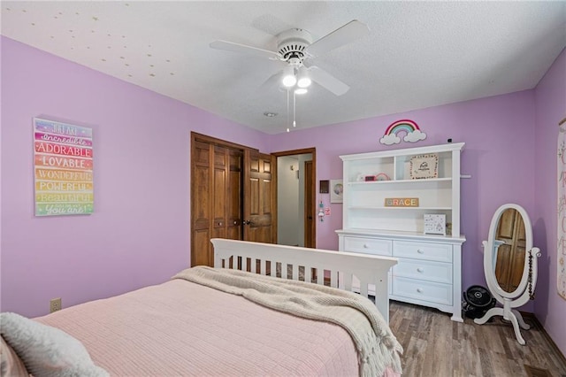 11530 Hemlock St, Overland Park, KS 66210 - bedroom with wood finished floors, ceiling fan, and a closet