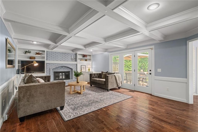 11530 Hemlock St, Overland Park, KS 66210 - living room featuring hardwood / wood-style flooring, beamed ceiling, built in features, a brick fireplace, and wainscoting